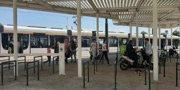 People in front of tram